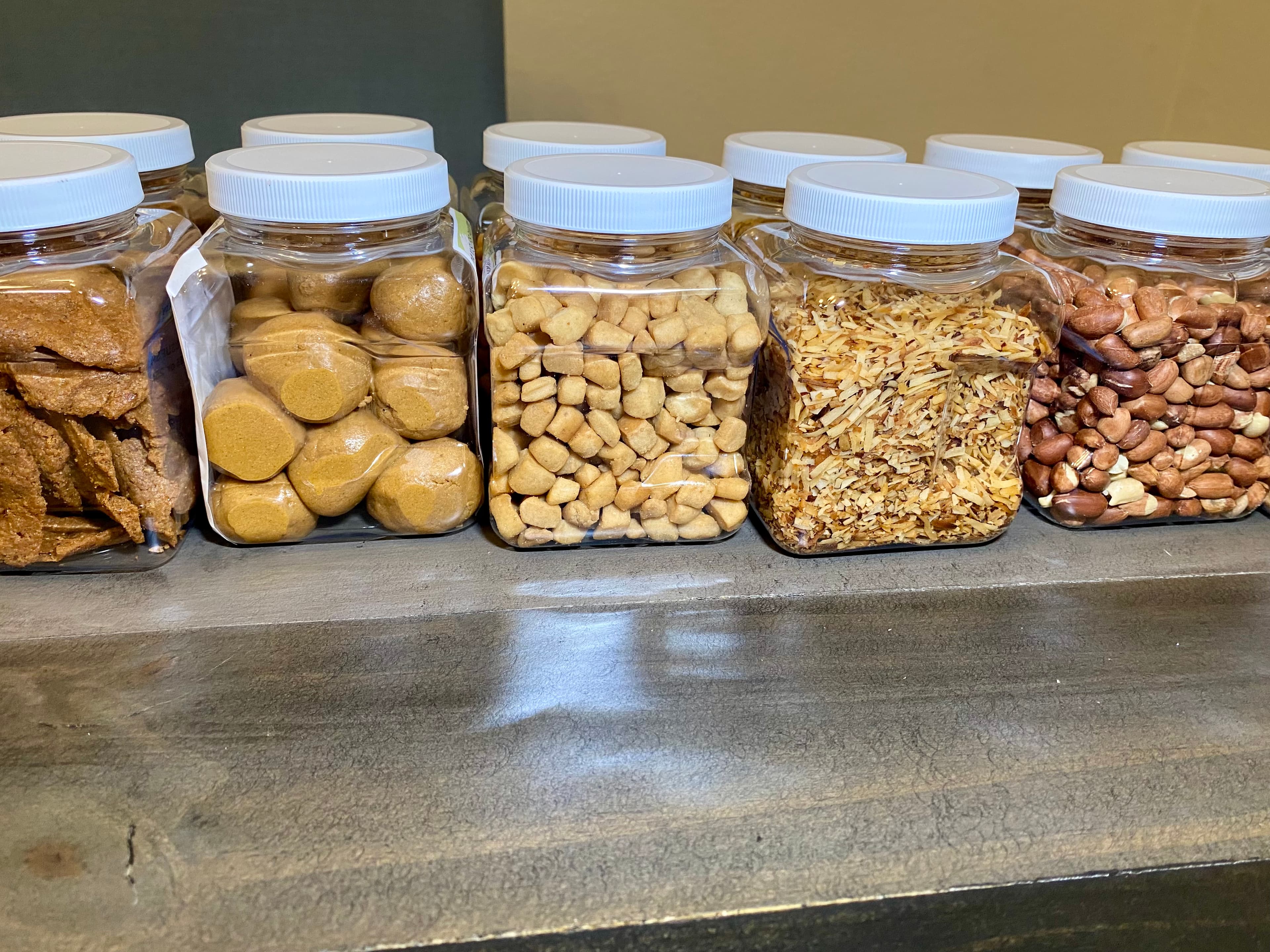 An assortment of snacks in clear pantry jars